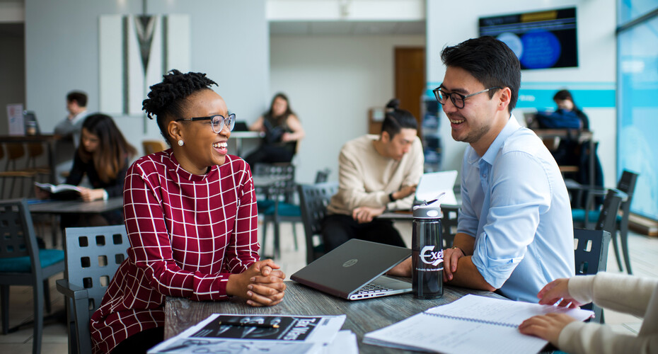 Two students discussing their studies in the Business School