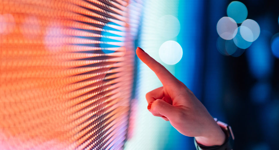 Persons finger pointing at a screen.